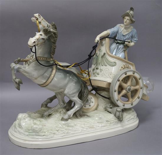 An Italian porcelain group of a figure, chariot and horses, height 34cm (a.f.)